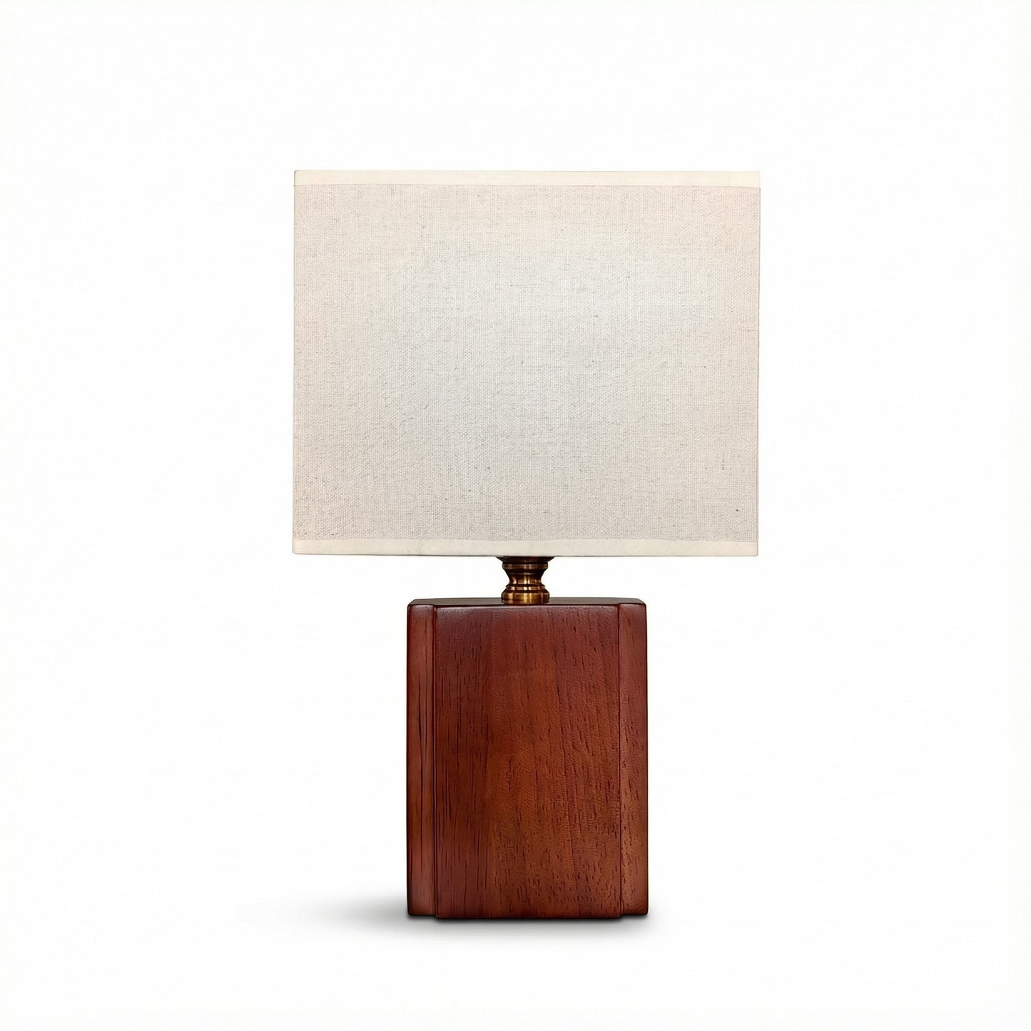 Table lamp with wooden base and white shade on a white background