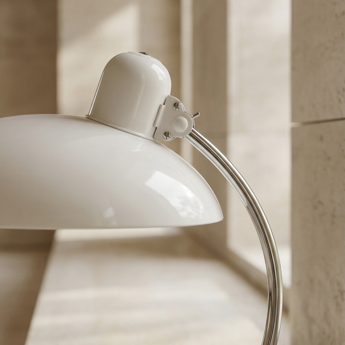 White lamp with a curved arm on a neutral background