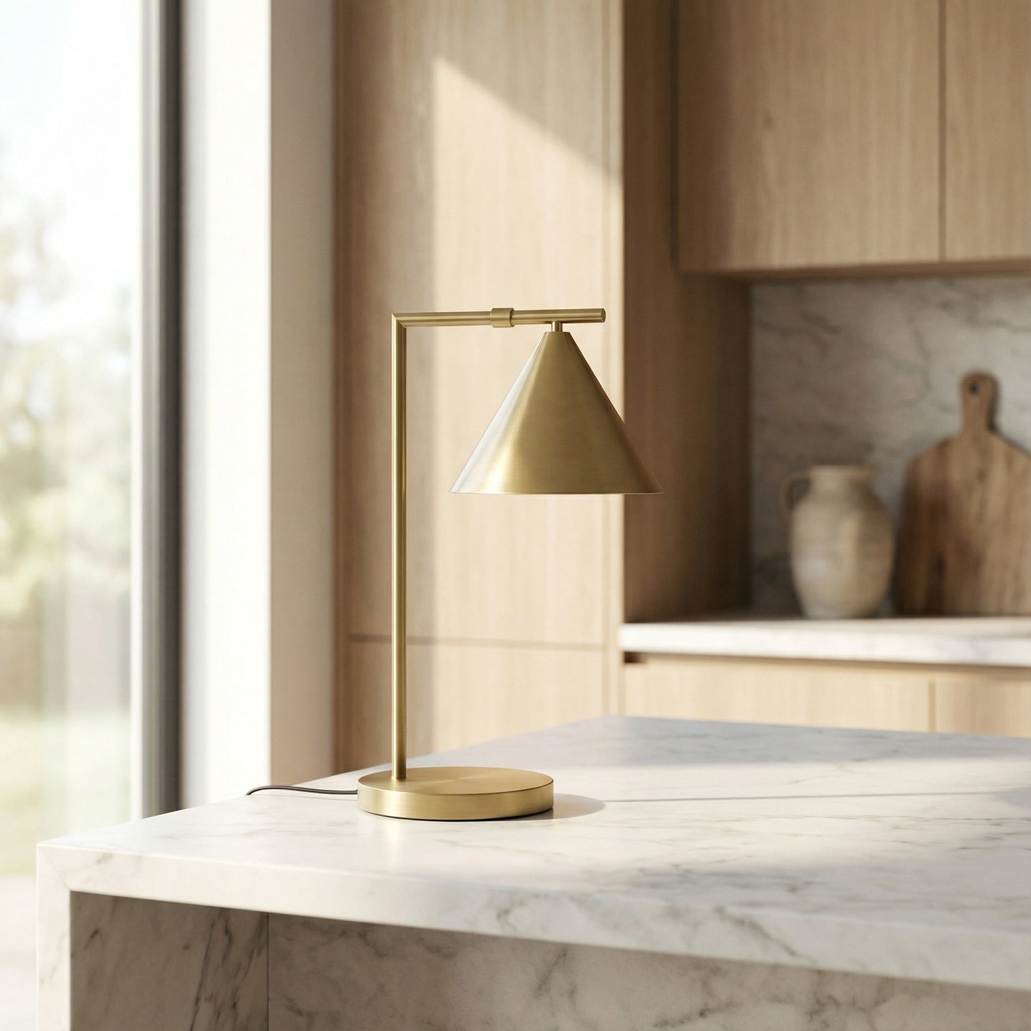 Gold table lamp on a marble surface with a kitchen background