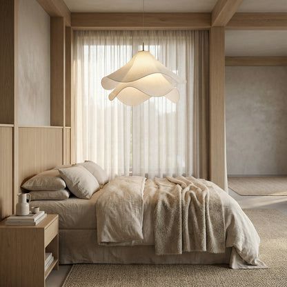 Modern bedroom with a bed, nightstand, and pendant light.