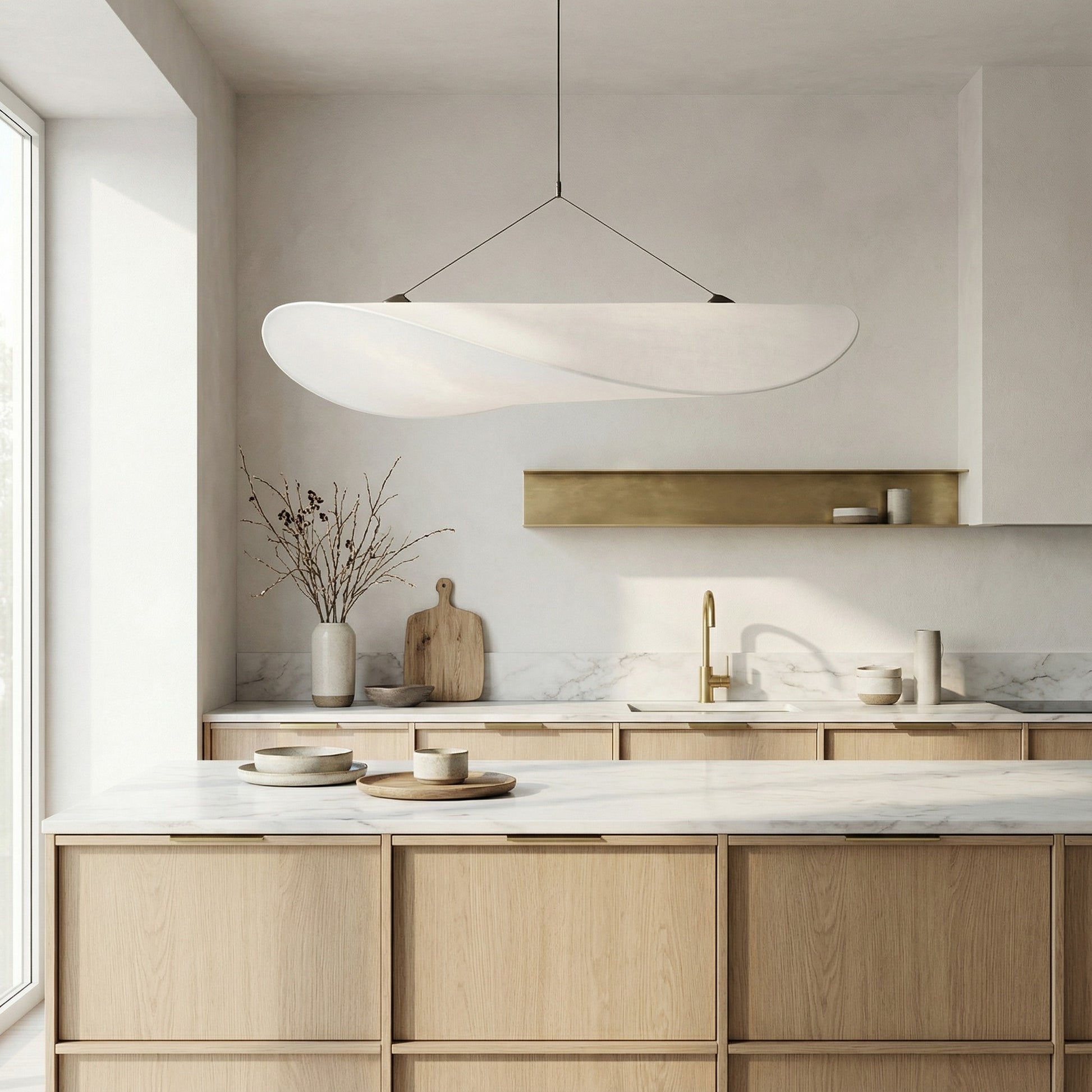Modern kitchen with wooden cabinets, marble countertops, and a pendant light.