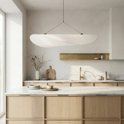Modern kitchen with wooden cabinets, marble countertops, and a pendant light.