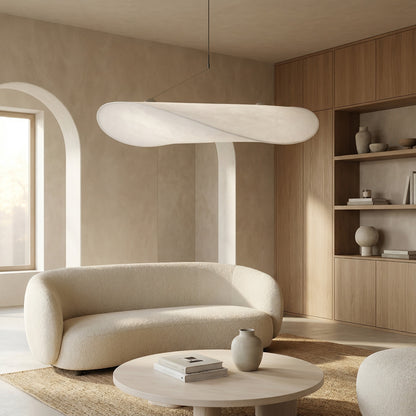 Modern living room with a beige sofa, round coffee table, and wooden shelves.