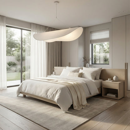 Modern bedroom with a large bed, side tables, and large windows.