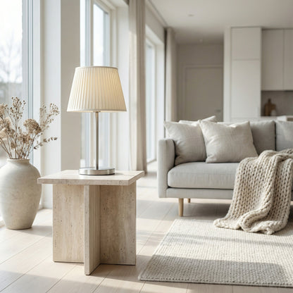 Modern living room with a lamp on a wooden side table, sofa, and rug.