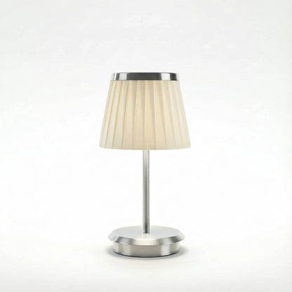 Table lamp with a beige shade and silver base on a white background