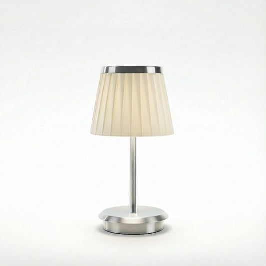 Table lamp with a beige shade and silver base on a white background