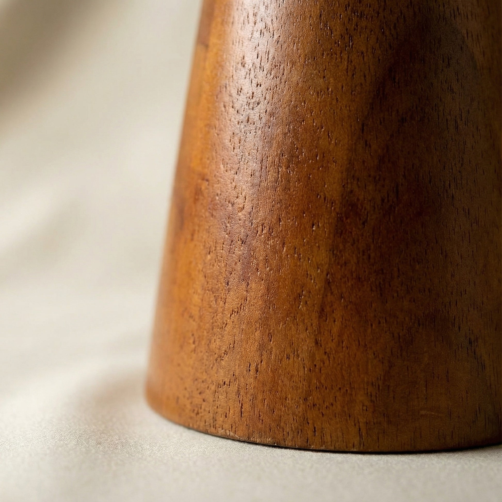 Close-up of a wooden object with a textured surface on a light background