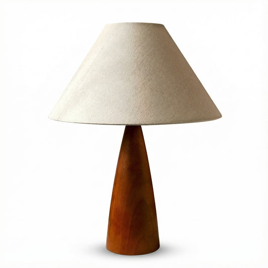Table lamp with wooden base and beige fabric shade on a white background