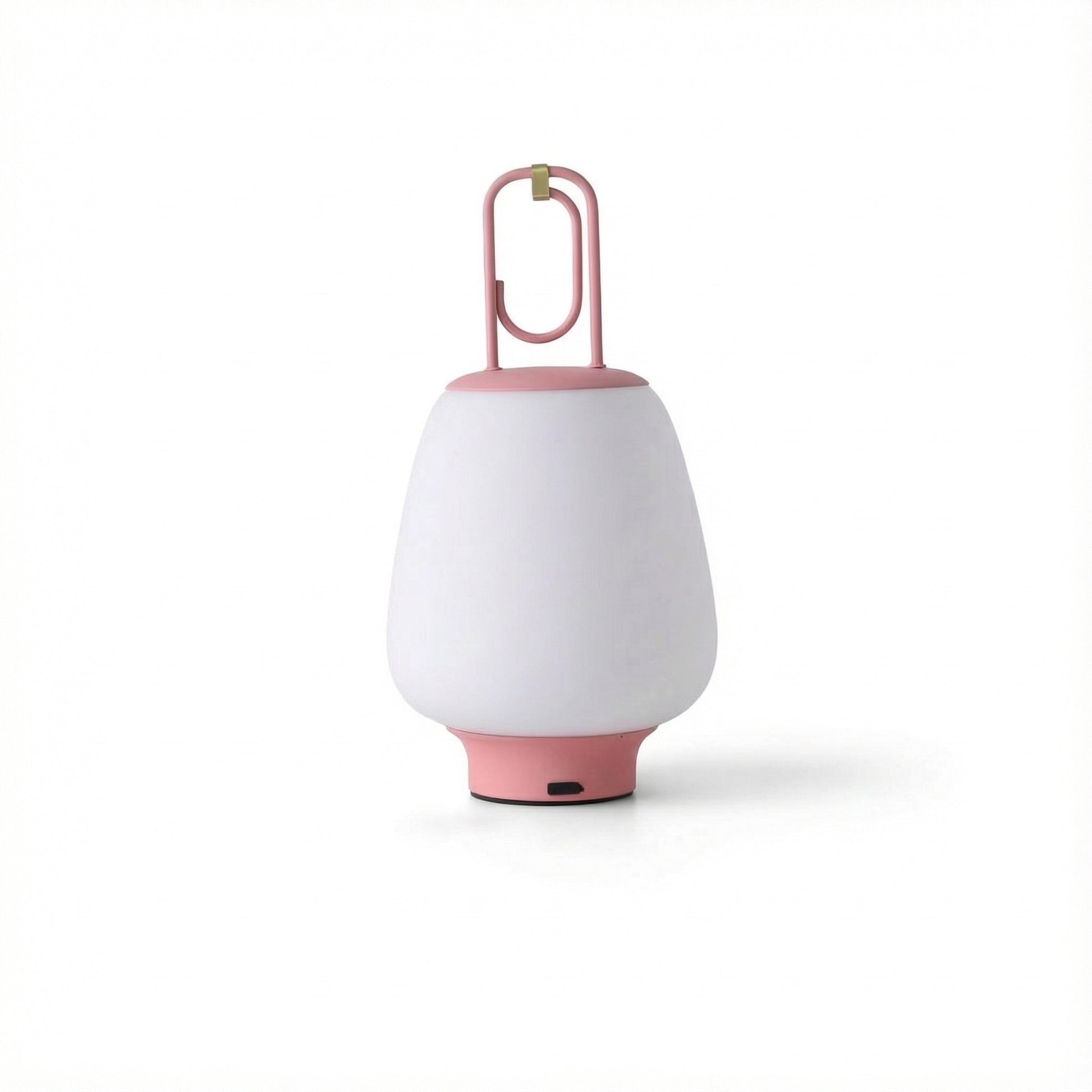 White portable lamp with pink base and handle on a white background