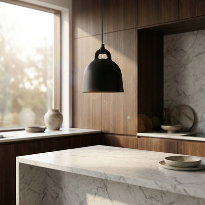 Modern kitchen with marble island, wooden cabinets, and a black pendant light.