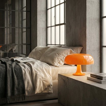 Modern bedroom with a bed, orange lamp, and concrete accents.