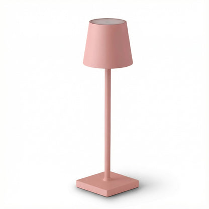 Pink table lamp with a square base on a white background