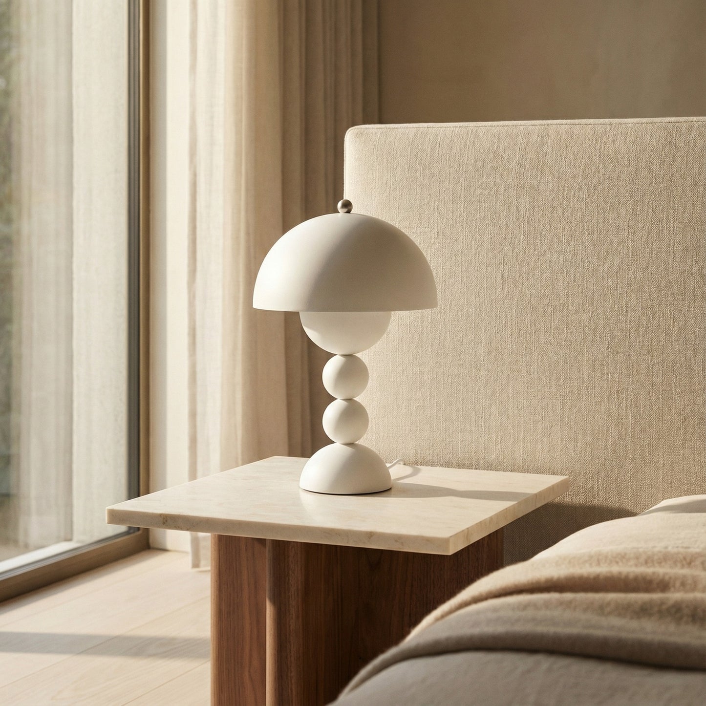 Modern table lamp on a side table next to a sofa with neutral tones.