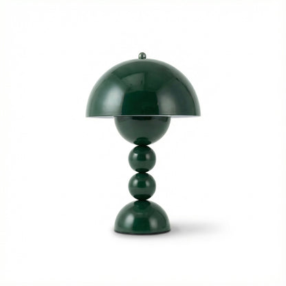 Green table lamp with a unique design on a white background