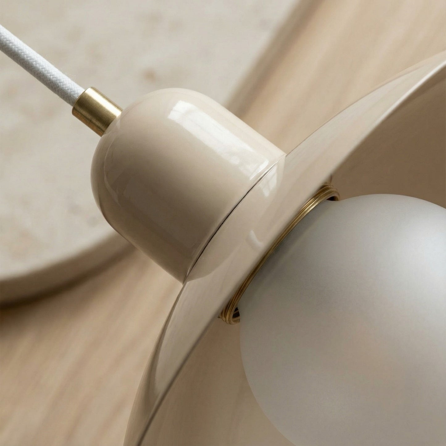 Close-up of a beige ceiling light fixture on a wooden surface