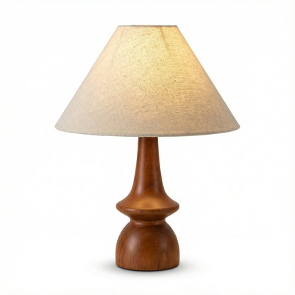 Table lamp with wooden base and beige lampshade on a white background