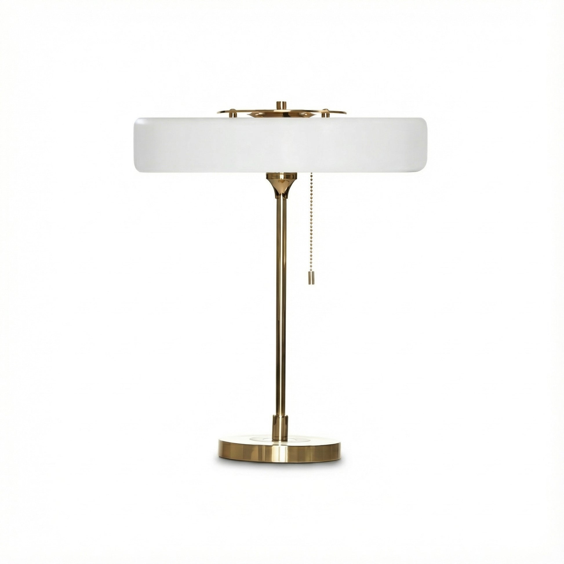 Table lamp with white shade and brass base on a white background