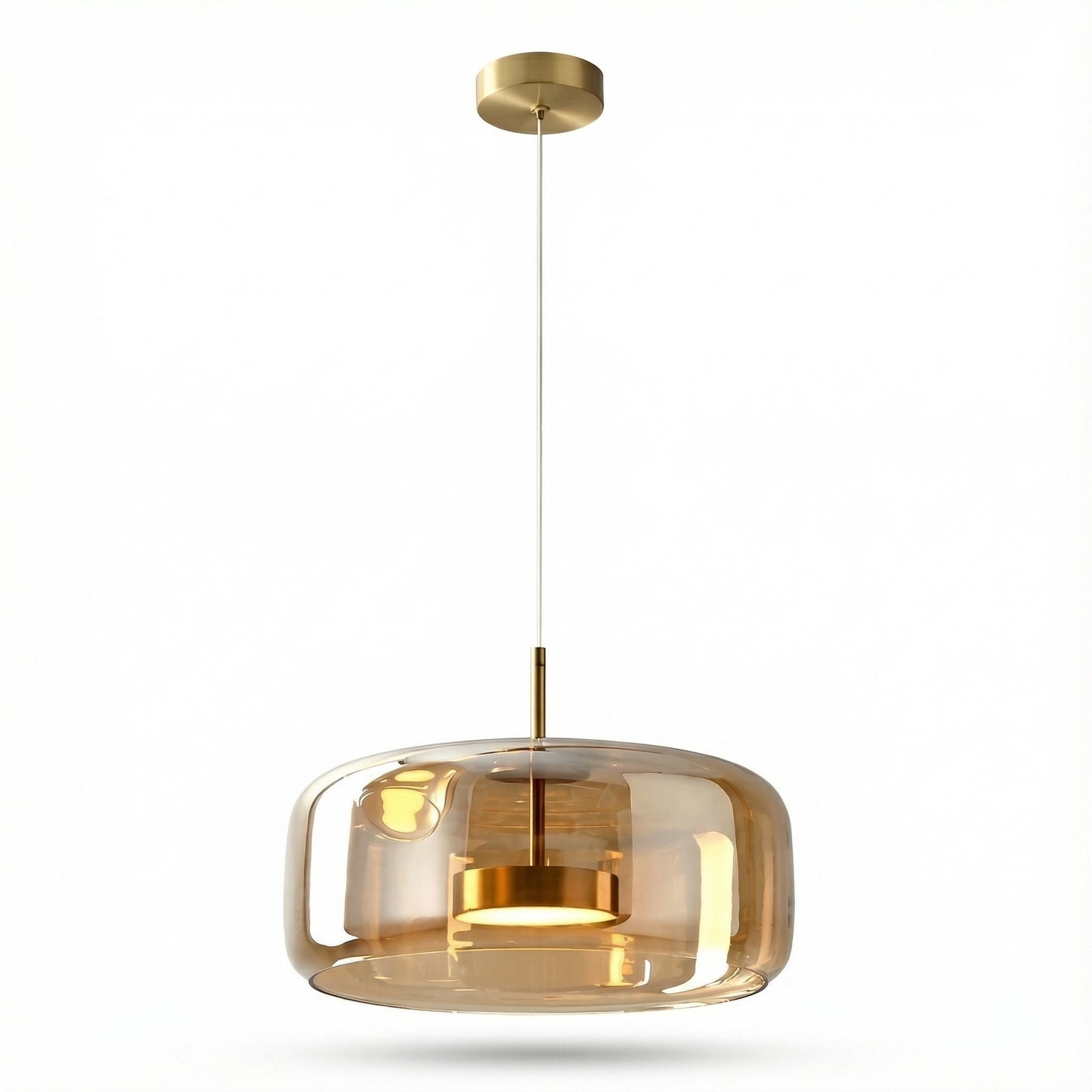 Modern pendant light with gold finish and transparent glass shade on a white background