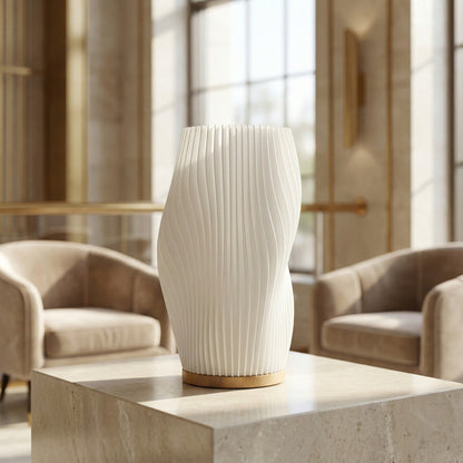 White textured vase on a stone surface with a blurred indoor setting